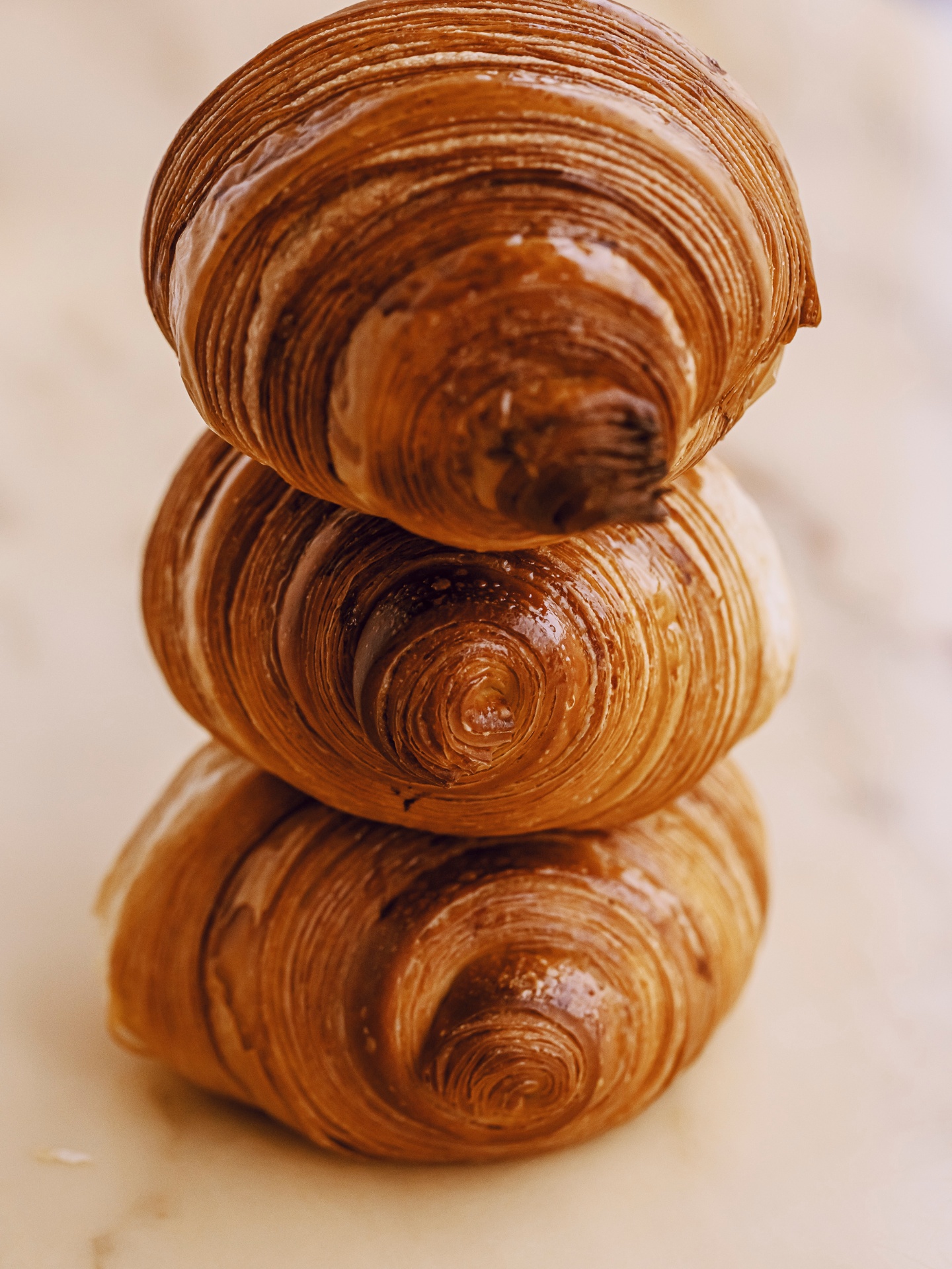 Stack of hand-laminated croissants showing flaky layers